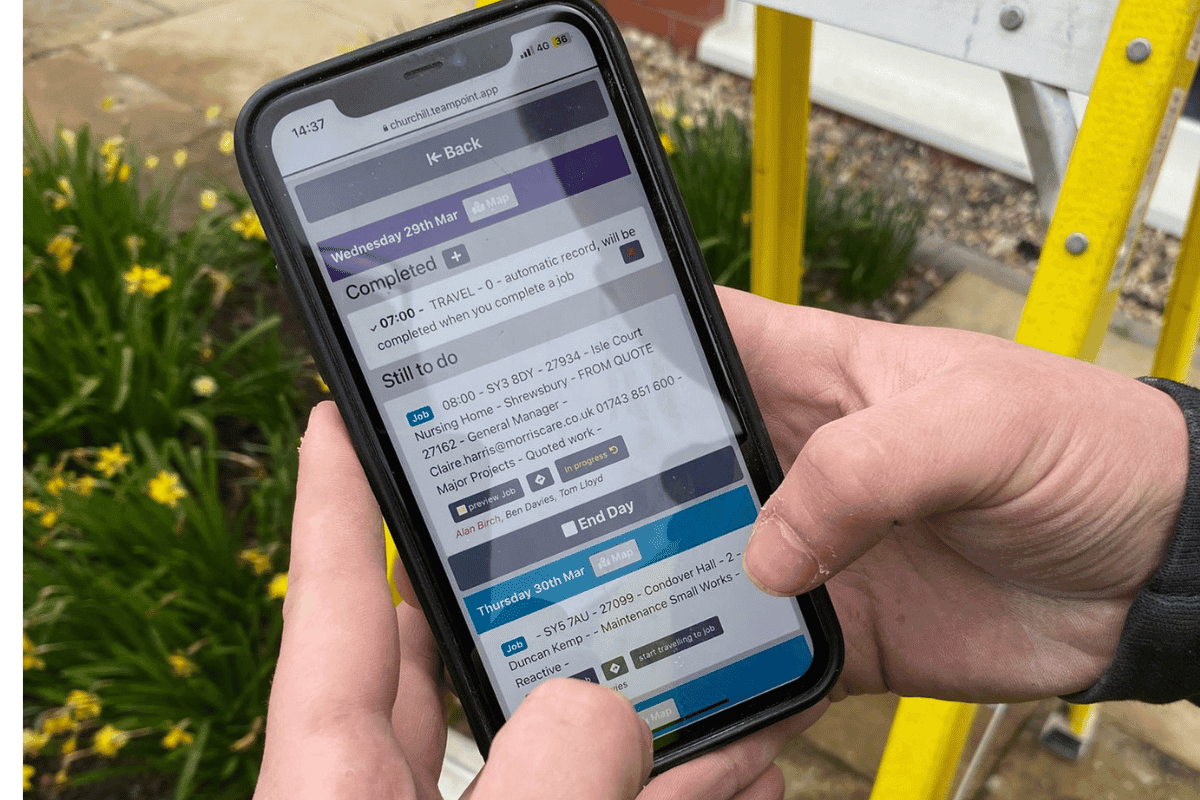 Engineer using the TeamPoint mobile app to view scheduled jobs, travel and daily work on site.
