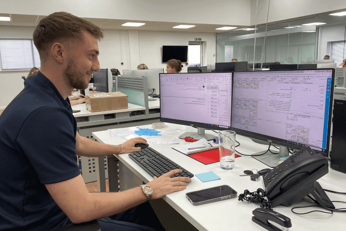 Operations team member using TeamPoint to manage scheduling, jobs and customer information from the office.